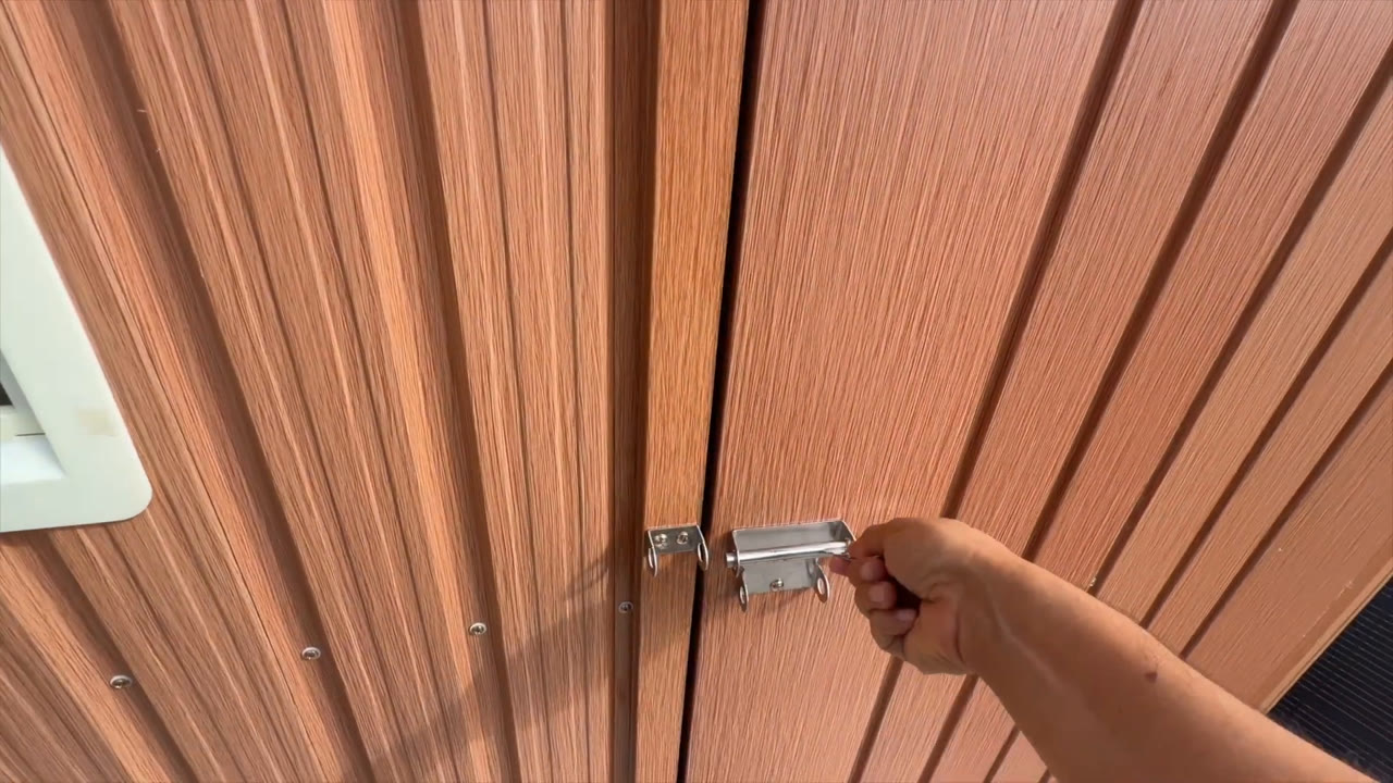 Close-up of the Florise 6x4 metal storage shed door latch and lock hasp