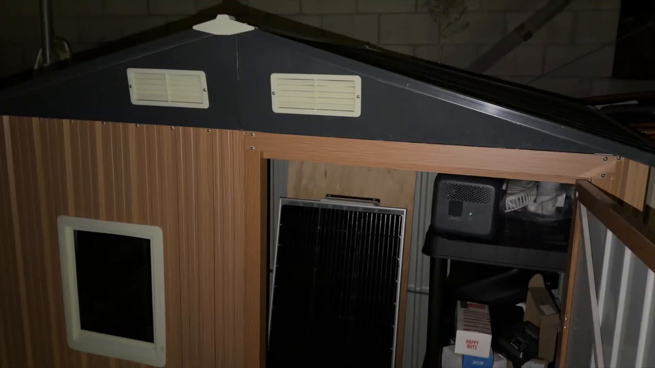 Florise 6x4 metal storage shed doorway and window with a portable power station and solar panel stored inside