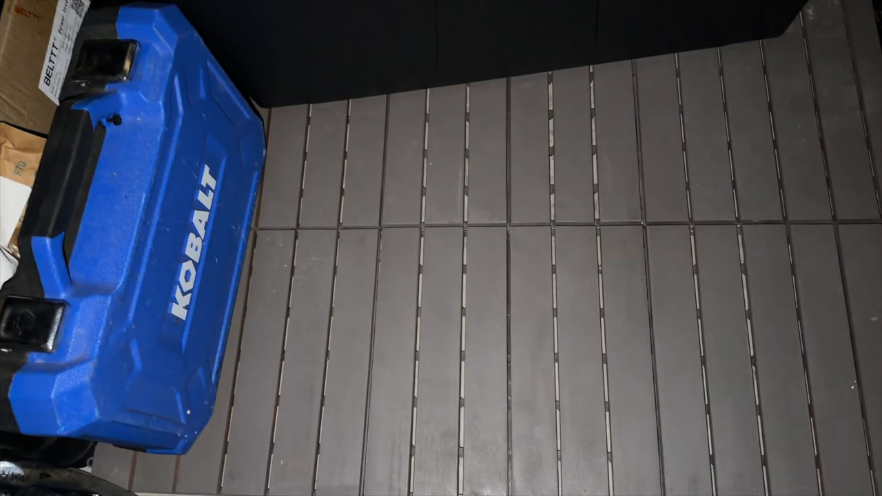 Interlocking deck tiles covering the floor inside the Florise 6x4 metal storage shed