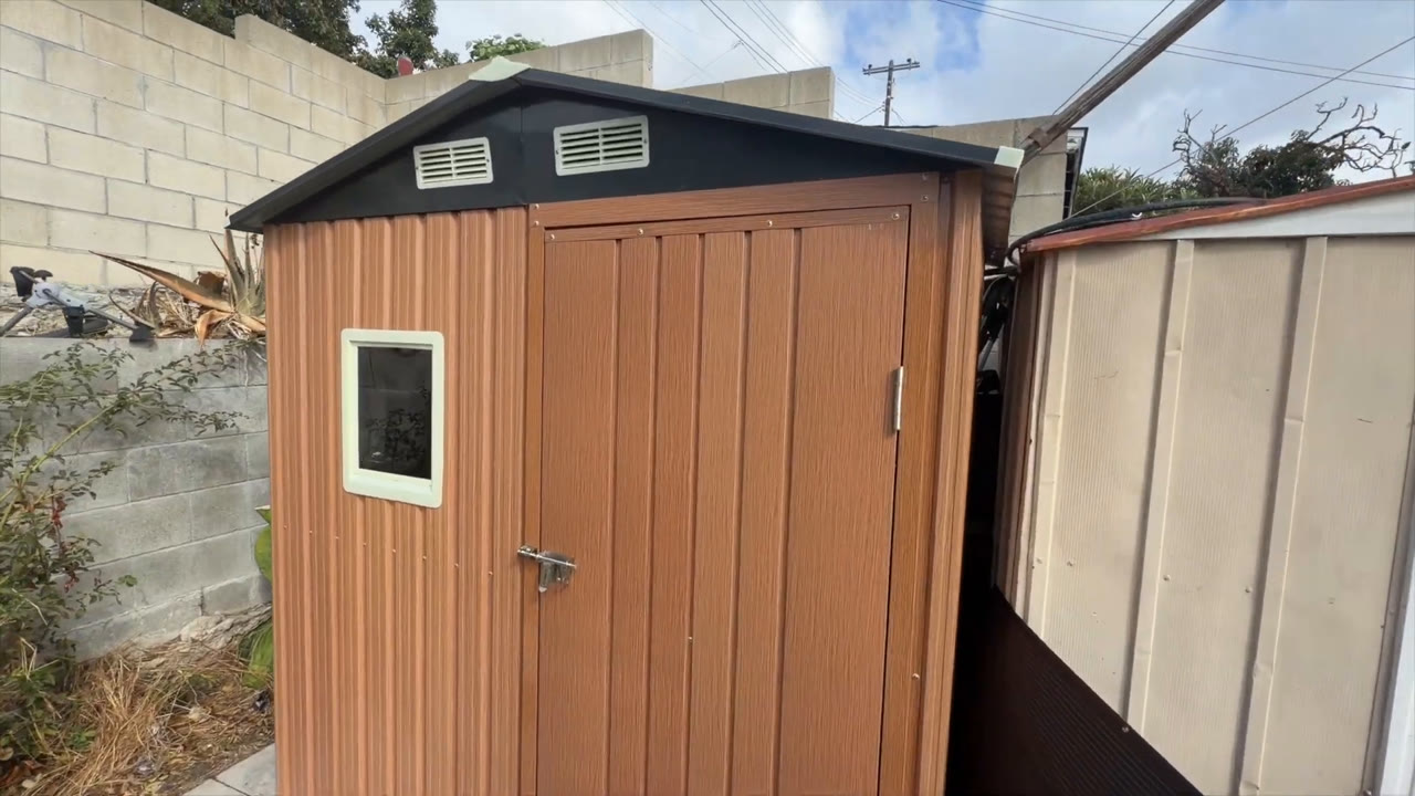 Side angle of the Florise 6x4 metal storage shed showing the window and two gable ventilation openings